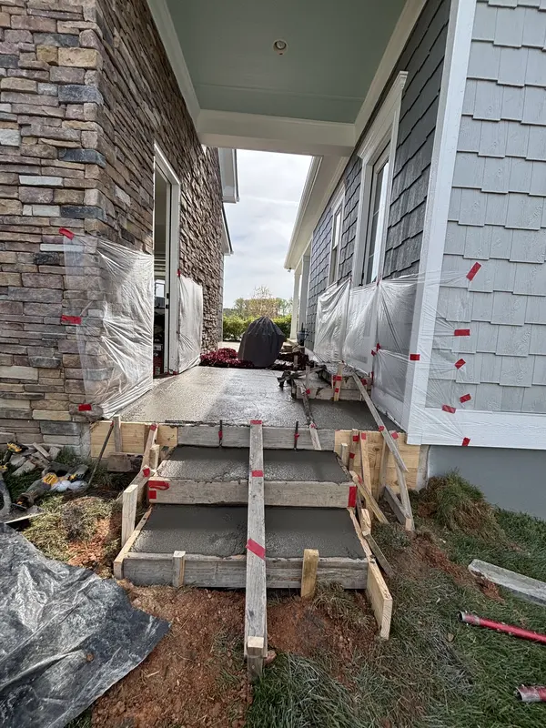 Bare dirt and stone where a side entry landing will be poured